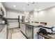 Modern kitchen featuring stainless steel appliances, kitchen island with seating, and sleek backsplash at 127 Manordale Dr, Chapel Hill, NC 27517