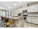 Kitchen featuring stainless steel appliances, granite countertops, backsplash, and kitchen island with seating at 127 Manordale Dr, Chapel Hill, NC 27517