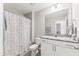 Well-lit bathroom featuring a granite countertop, a shower with a patterned curtain, and neutral tones at 1310 Compass Dr, Durham, NC 27713