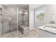 Modern bathroom featuring a frameless glass shower with a built-in bench and natural lighting at 1310 Compass Dr, Durham, NC 27713
