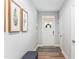 Bright and inviting entryway featuring modern decor, a white door, and a comfortable bench with storage at 1310 Compass Dr, Durham, NC 27713