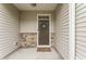 Charming entryway with stone accents, a 'Welcome' mat, and a decorative wreath on the front door at 1310 Compass Dr, Durham, NC 27713
