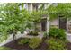 Charming front entrance framed by lush greenery, leading to a welcoming front door at 1310 Compass Dr, Durham, NC 27713
