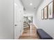 Inviting hallway with hardwood floors, staircase, and decorative art at 1310 Compass Dr, Durham, NC 27713
