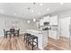 Modern kitchen features stainless appliances, island with seating and an adjacent dining area at 1310 Compass Dr, Durham, NC 27713