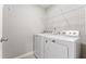 Functional laundry room with modern washer and dryer, ample space, and a wire shelving unit at 1310 Compass Dr, Durham, NC 27713