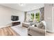 Cozy living room with plush seating, large windows, and a modern entertainment center at 1310 Compass Dr, Durham, NC 27713