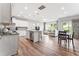 Open-concept living space showcasing the kitchen, dining area, and living room with hardwood floors and natural light at 1310 Compass Dr, Durham, NC 27713