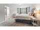 Bright main bedroom with carpet, large window, and a full ensuite bathroom at 1310 Compass Dr, Durham, NC 27713