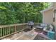 Relaxing back deck with wooded views, gas grill, and cozy patio furniture, perfect for outdoor entertaining at 137 Lanigan Pl, Cary, NC 27513