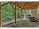 Back patio with wood ceiling beams and railing overlooking the trees at 137 Lanigan Pl, Cary, NC 27513