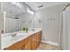 Bathroom with double sinks, wooden cabinets, and a large mirror above vanity at 137 Lanigan Pl, Cary, NC 27513