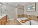 Bright bathroom featuring a soaking tub, neutral decor, and tile accents at 137 Lanigan Pl, Cary, NC 27513