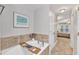 Bright bathroom featuring a soaking tub, neutral decor, and tile accents at 137 Lanigan Pl, Cary, NC 27513