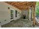 Back covered patio with concrete floor, grilling area, exterior access, and wooded view at 137 Lanigan Pl, Cary, NC 27513