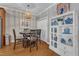 Charming dining area boasts hardwood floors, a modern light fixture, and a decorative shelving unit at 137 Lanigan Pl, Cary, NC 27513