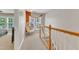 Hallway with cozy sitting area featuring egg chair and natural lighting from nearby window at 137 Lanigan Pl, Cary, NC 27513