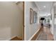 Hallway with hardwood floors leads to the living area and features decorative wall art at 137 Lanigan Pl, Cary, NC 27513
