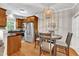 Bright eat-in kitchen featuring wooden cabinets, stainless steel appliances, and a charming light fixture at 137 Lanigan Pl, Cary, NC 27513
