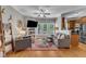 Comfortable living room with hardwood floors, a ceiling fan, and views of the outdoors through large windows at 137 Lanigan Pl, Cary, NC 27513