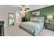 Comfortable bedroom featuring a green accent wall, stylish furnishings, and a ceiling fan at 137 Lanigan Pl, Cary, NC 27513