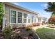 The backyard has a grass area, landscaping and an exterior view of the back of the house with lots of windows at 1405 Ventnor Pl, Cary, NC 27519