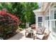 Outdoor stone patio with seating and meticulously maintained landscaping at 1405 Ventnor Pl, Cary, NC 27519