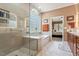 Bathroom featuring walk-in shower, soaking tub, and ensuite access at 1405 Ventnor Pl, Cary, NC 27519