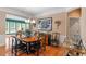 Dining room features hardwood floors, elegant lighting, and large windows at 1405 Ventnor Pl, Cary, NC 27519