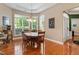 Cozy dining area with a wooden table set with four chairs and sunlit by multiple windows at 1405 Ventnor Pl, Cary, NC 27519
