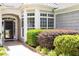 Close up on the front of house showing bay window and neatly manicured landscaping around the entrance at 1405 Ventnor Pl, Cary, NC 27519