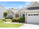 Charming front exterior with lush landscaping and attached garage at 1405 Ventnor Pl, Cary, NC 27519