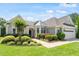 Charming single-story home featuring a well-manicured lawn, tidy landscaping, and an attached two-car garage at 1405 Ventnor Pl, Cary, NC 27519