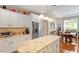 Kitchen features granite countertops, stainless steel refrigerator, and breakfast area at 1405 Ventnor Pl, Cary, NC 27519