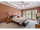 Comfortable main bedroom featuring a decorative ceiling, ceiling fan, and lots of natural light at 1405 Ventnor Pl, Cary, NC 27519