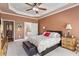 Comfortable main bedroom featuring a decorative ceiling, ceiling fan, and ensuite access at 1405 Ventnor Pl, Cary, NC 27519