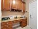Well-lit home office with custom wood cabinets and granite countertops at 1405 Ventnor Pl, Cary, NC 27519