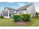 Landscaped backyard with a patio, enclosed sunroom, and well-maintained lawn, perfect for outdoor enjoyment at 1520 Palmer Hill Dr, Durham, NC 27703