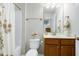 A well-maintained bathroom featuring a shower, white toilet, and a wooden cabinet vanity at 1520 Palmer Hill Dr, Durham, NC 27703