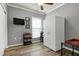 Neutral bedroom with a ceiling fan, TV and hardwood floors at 1520 Palmer Hill Dr, Durham, NC 27703