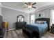 Comfortable bedroom with a queen-sized bed, hardwood floors, and neutral decor at 1520 Palmer Hill Dr, Durham, NC 27703