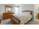 Cozy bedroom with a wooden bed frame, dresser, and soft natural light creating a serene retreat at 1520 Palmer Hill Dr, Durham, NC 27703