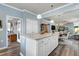 Open kitchen view featuring a granite island, white cabinets, and stainless steel appliances at 1520 Palmer Hill Dr, Durham, NC 27703