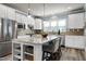 Bright kitchen with a spacious granite island, stainless steel appliances, and modern white cabinetry at 1520 Palmer Hill Dr, Durham, NC 27703