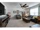 Inviting living room featuring leather seating, a ceiling fan, and a cozy atmosphere for relaxation at 1520 Palmer Hill Dr, Durham, NC 27703