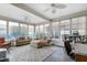 Bright sunroom with lots of natural light, hardwood floors, and a ceiling fan at 1520 Palmer Hill Dr, Durham, NC 27703