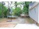 Backyard featuring a patio, deck, trampoline, and basketball hoop at 1536 Granville Street, Burlington, NC 27215