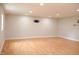 Finished basement featuring light hardwood floors, recessed lighting, and wall-mounted TV bracket at 1536 Granville Street, Burlington, NC 27215