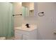 This bathroom features a vanity sink with storage, mirrored cabinet, and black towel rack, and curtain at 1536 Granville Street, Burlington, NC 27215