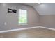 Slanted ceiling bedroom with light walls and floors, complete with a TV mount at 1536 Granville Street, Burlington, NC 27215